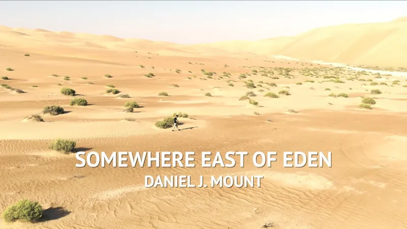 Image of a person walking alone in the desert with the superimposed words "Somewhere East of Eden Daniel J. Mount"