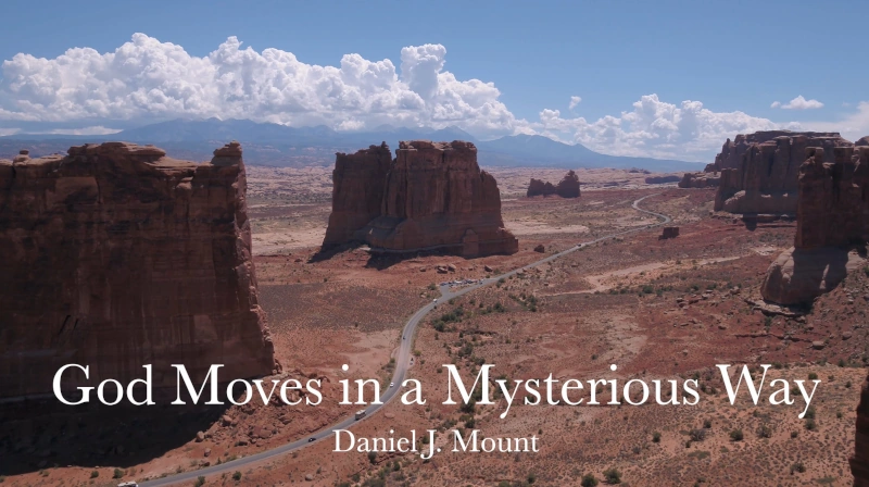 Words: God Moves in a Mysterious Way, Daniel J. Mount, superimposed on red rock formations from the American West, with clouds and mountains in the background